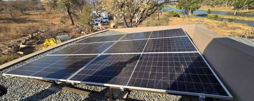 Solar panels on an angled frame over gravel