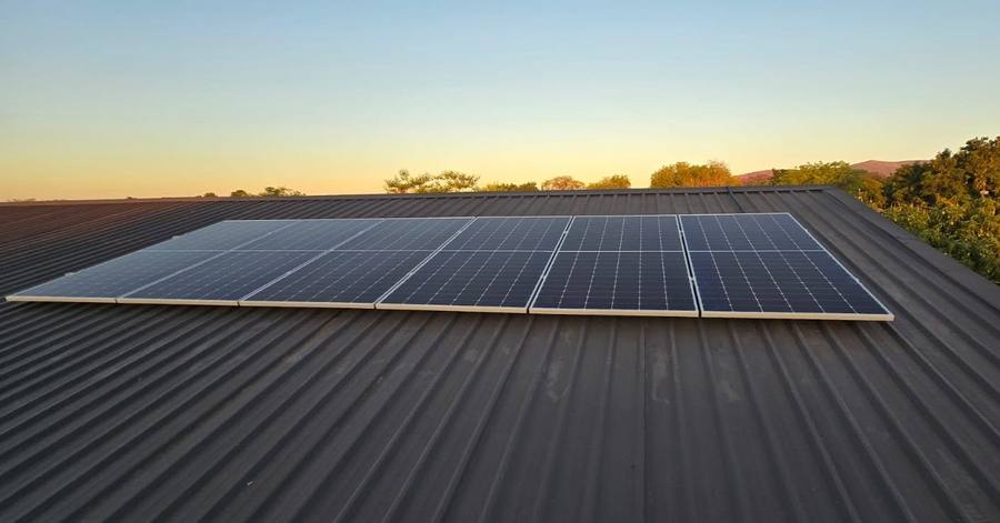 Solar panels at dusk on a corrugated roof