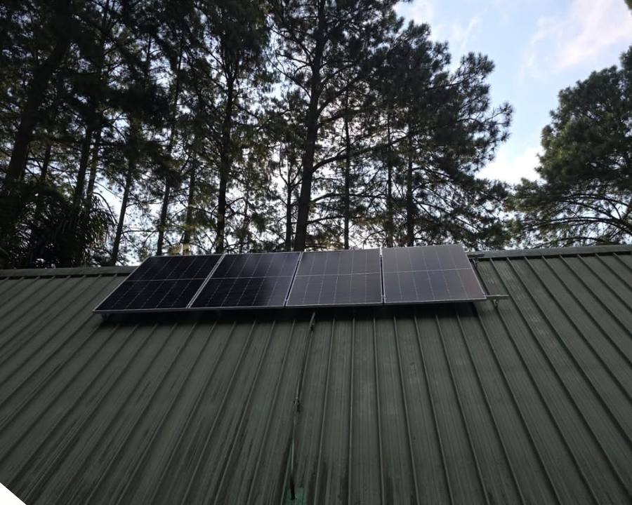Small solar array on a dark green roof