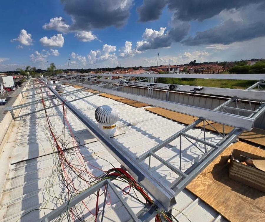 Mounting rails and cabling on a roof before panels go on