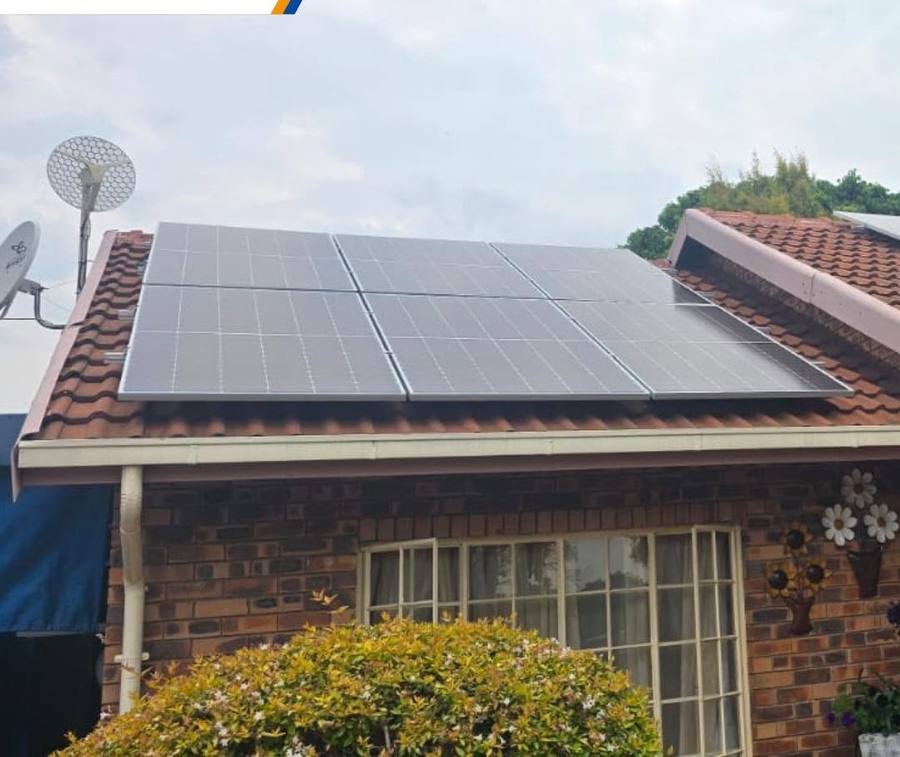 Solar panels on a brick house with a tiled roof