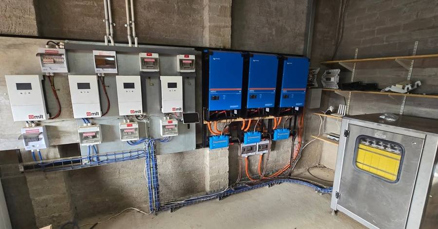 Row of inverters mounted on a brick plant-room wall